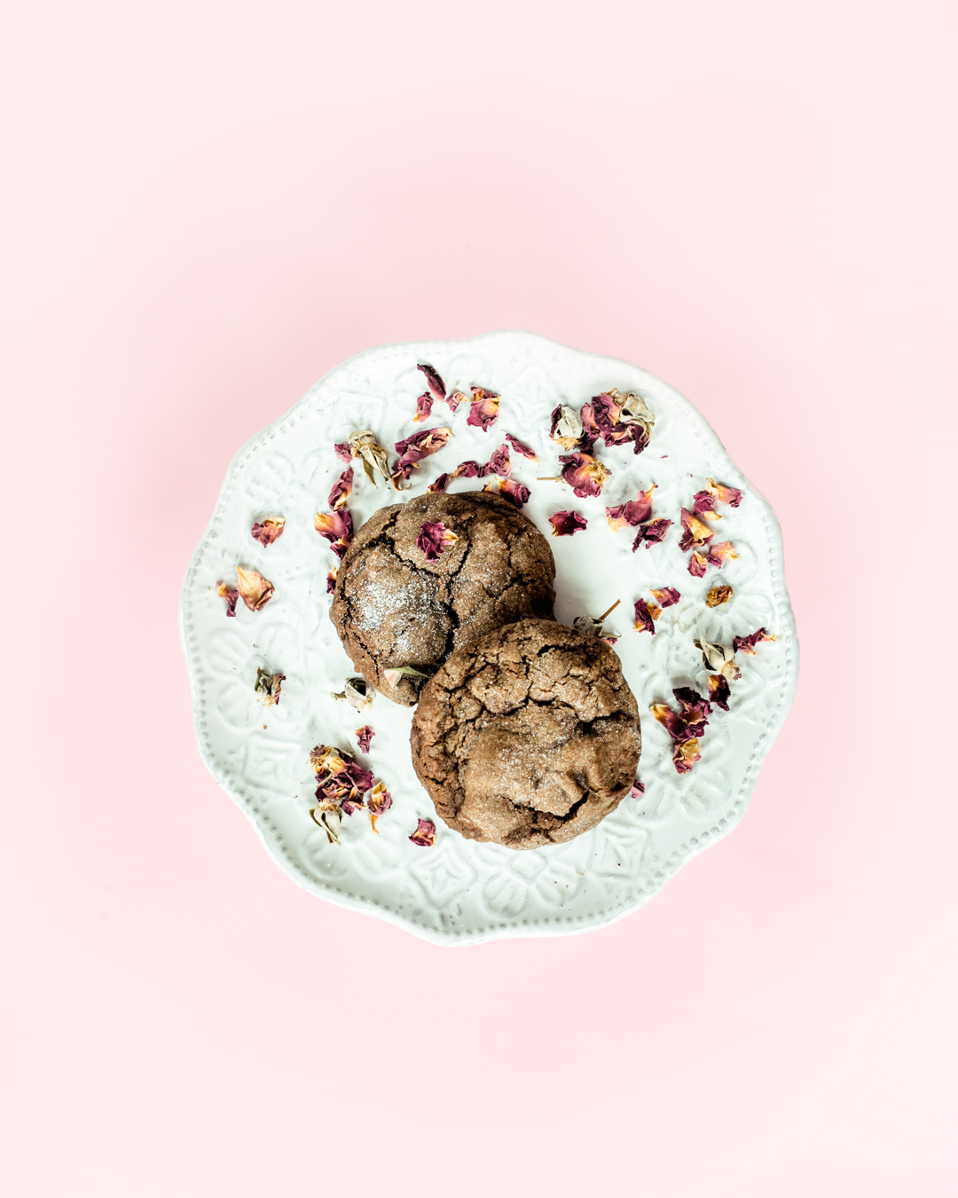 chewy chocolate chocolate chip cookies on a plate with edible flowers