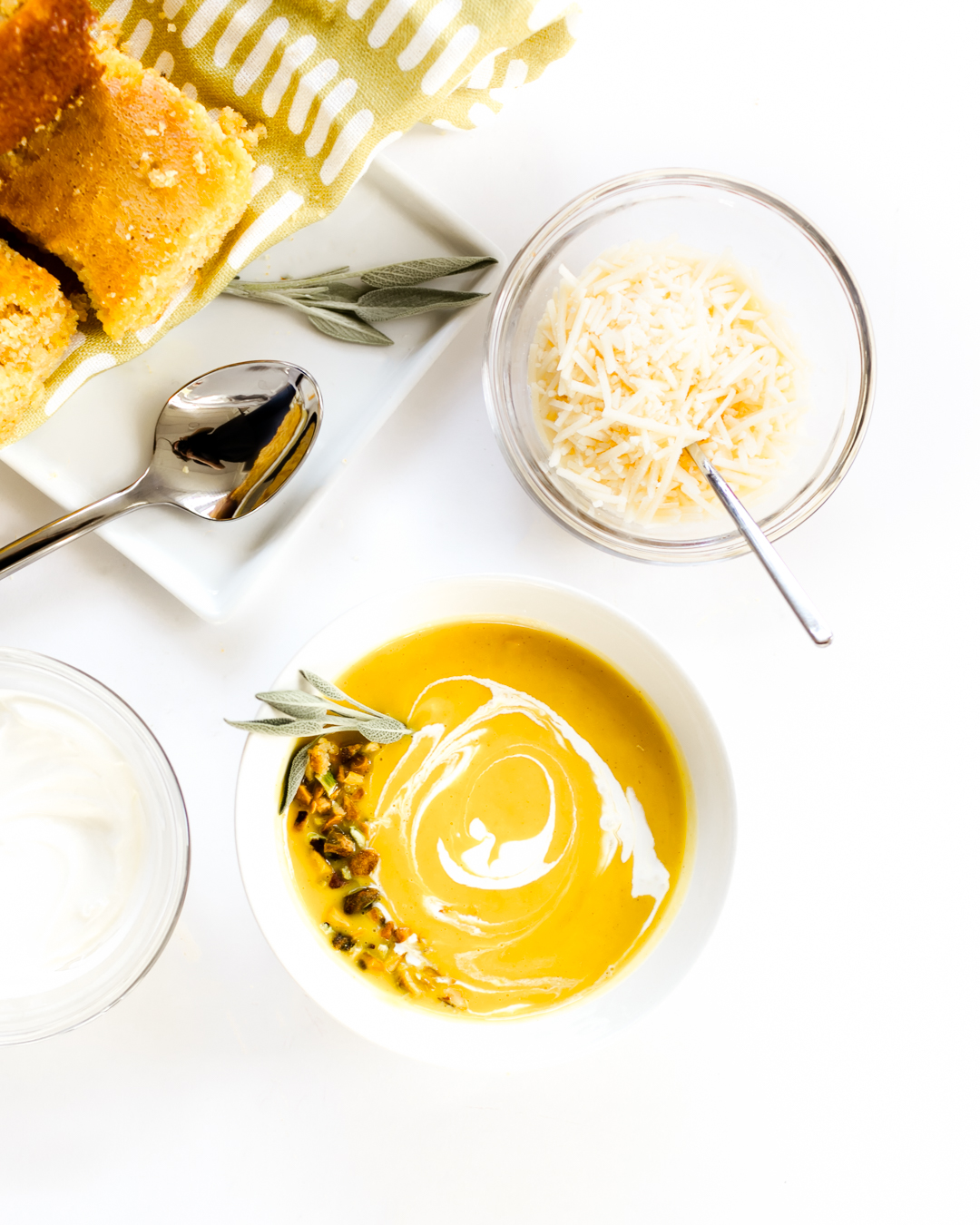Butternut Squash Soup Bowl Topped with Herbs and Sour Cream Drizzle