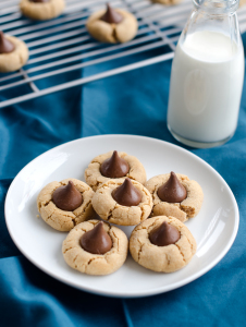 IRRESISTIBLE (and easy) peanut butter kiss cookies made with Hershey kisses and peanut butter cookie dough. I love this cookie recipe so much! It's also fun to do with kids! | www.chicandsugar.com