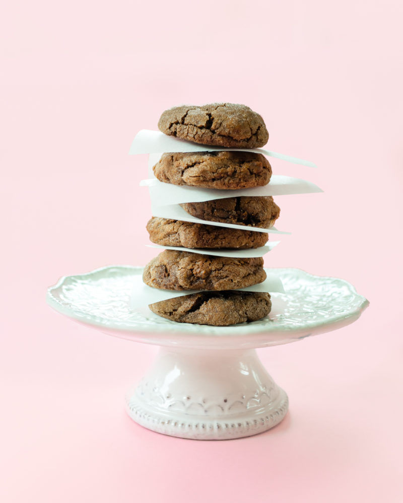 Chewy chocolate chocolate chip cookies stacked on a plate